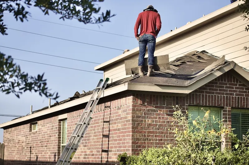 Professional roofer working on a residential roof in Randallstown